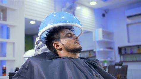 A Young Man Enjoying Hair Spa Steam Deep Conditioning In A S