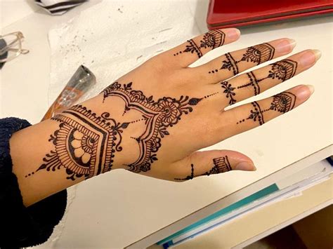 A Womans Hand With Henna Tattoos On It