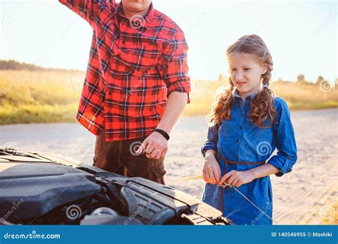 Father and Daughter Fixing Problems with Car during Summer Road Trip