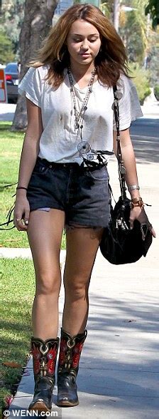 Miley Cyrus Continues The Daisy Dukes And Cowgirl Boots Theme Daily Mail Online