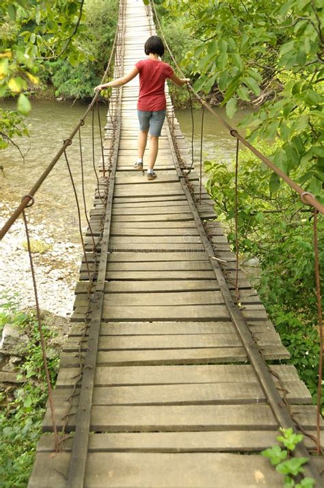 girl walking on a wooden bridge over a river stock image image of girl hike 44713317