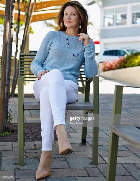 Portrait Of Elegant Mature Woman Sitting On Patio Chair