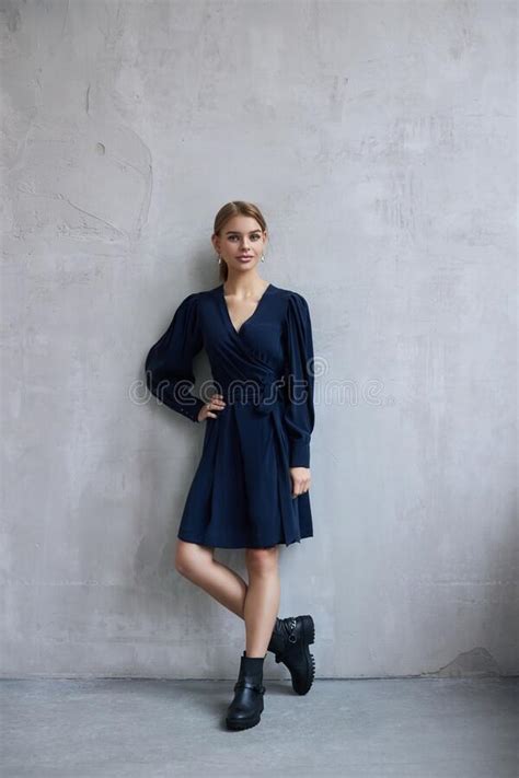 Fashion Beautiful Woman In Dress Is Standing Against The Wall Perfect