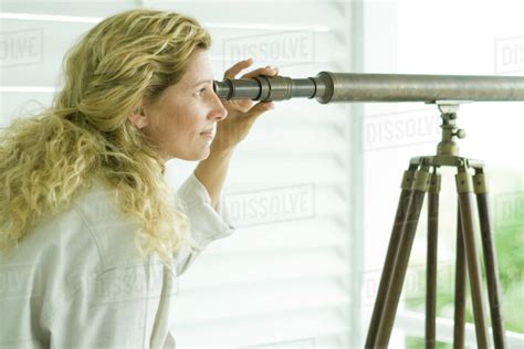 Woman Looking Through Telescope Side View Stock Photo Dissolve