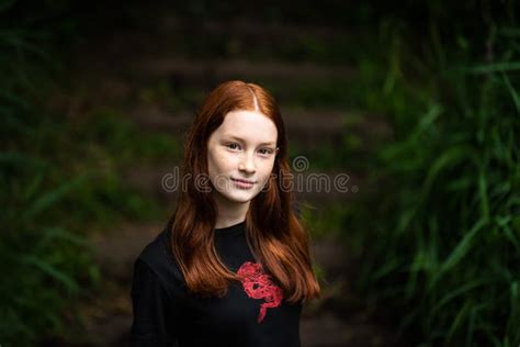 Red Haired Twelve Year Old Girl With Freckles Posing With A Nature