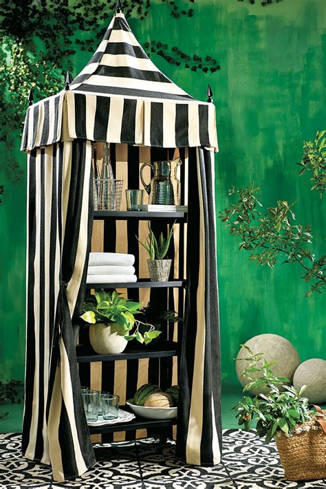 A Black And White Striped Gazebo Sitting On Top Of A Table Next To