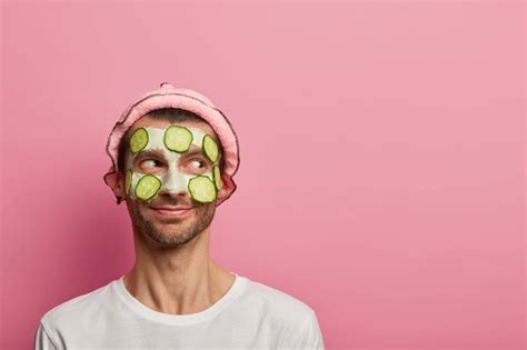 Free Photo Good Tempered Happy Man Wears Face Mask And Cucumbers