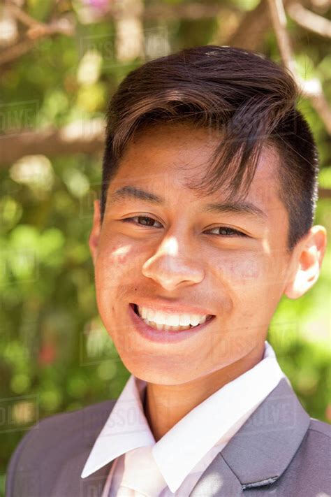 Portrait Of Smiling Hispanic Boy Wearing Suit Stock Photo Dissolve