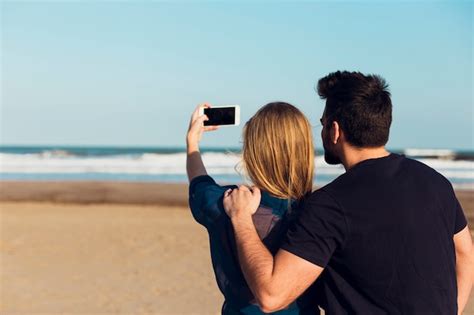 Free Photo Anonymous Couple Taking Selfie On Beach