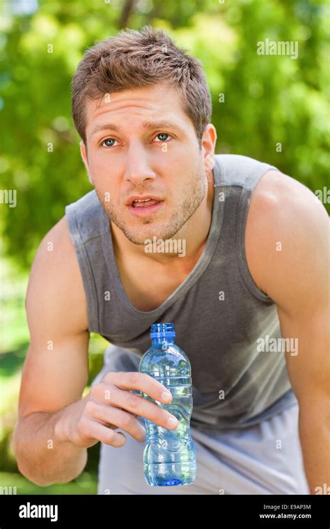 Sporty Man Drinking Water In The Park Stock Photo Alamy