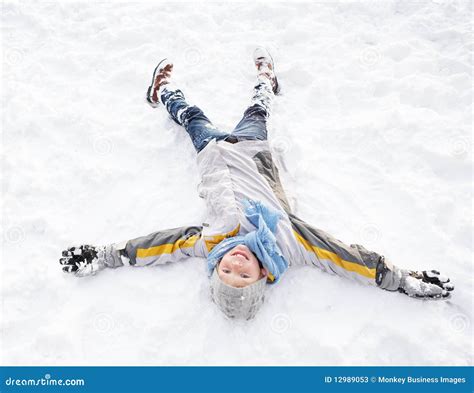 Boy Laying On Ground Making Snow Angel Stock Image Image Of Laughing