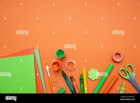 School Supplies Stationery Border On Orange Color Background Top View