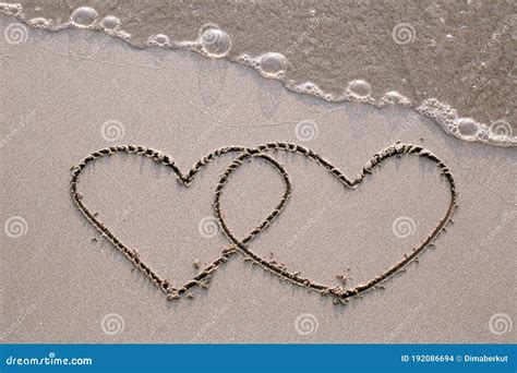 Two Hearts Drawn On The Sand Of A Sea Beach Stock Photo Image Of