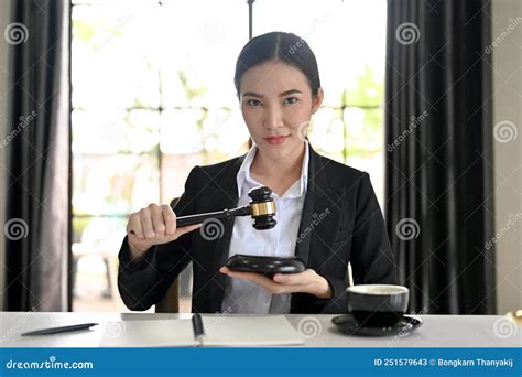 Portrait Attractive And Successful Asian Female Lawyer Holding A Judge