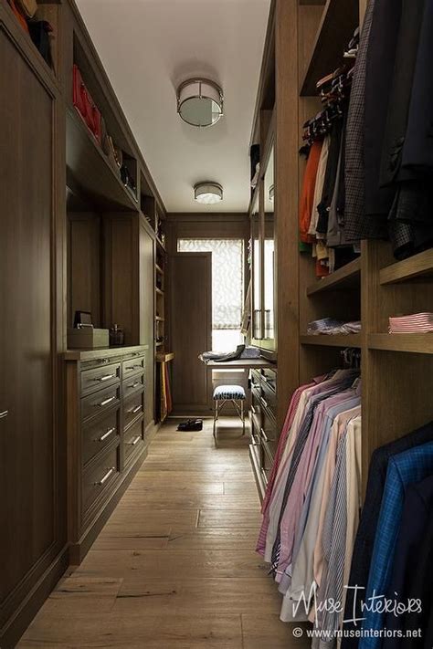 Long Traditional Masculine Closet Is Fitted With Dark Stained Built Ins