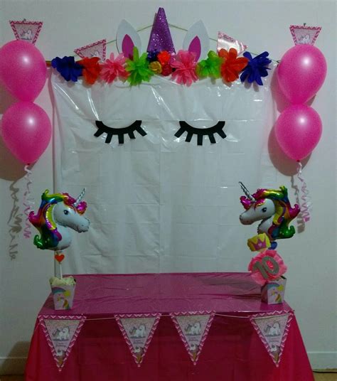 A Unicorn Themed Birthday Party With Balloons And Decorations