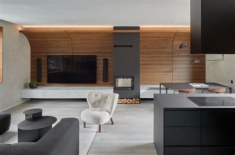 A Curved Wood Slat Accent Wall Spans The Living Room And Dining Area Of