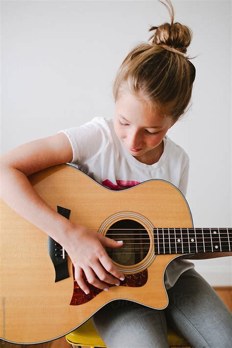 Young Girl Playing Guitar By Stocksy Contributor Erin Drago Stocksy