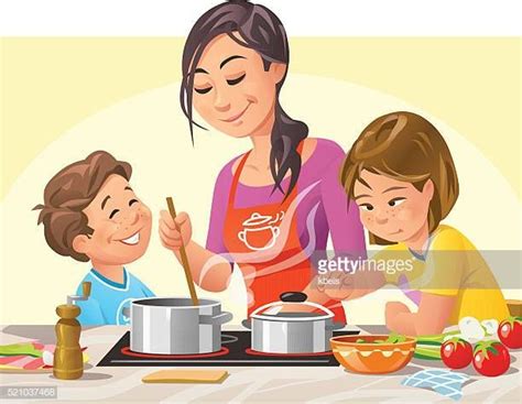 Mother And Two Children Cooking And Preparing A Meal In The Kitchen