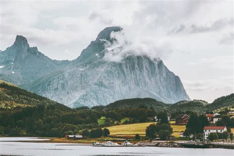 Rocky Mountains Landscape In Norway Clouds Rocks Above Village And
