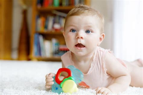 Cute Baby Girl Playing With Colorful Rattle Toys Stock Image Image Of