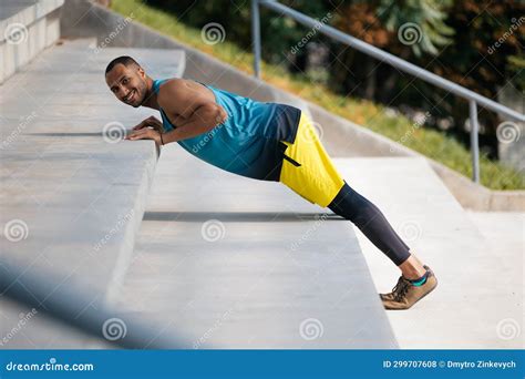 Good Looking Dark Skinned Athlete Exercising On The Stairs Stock Photo