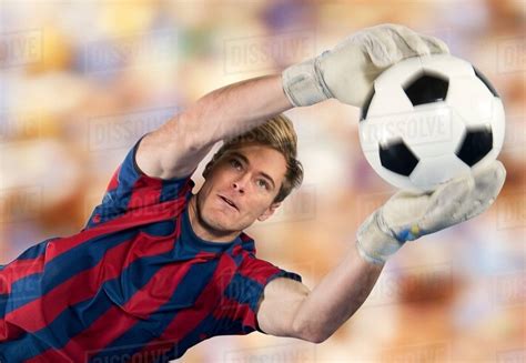 Soccer Player Catching Ball In Air Stock Photo Dissolve