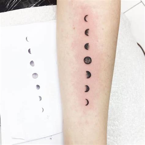 A Womans Arm With Phases Of The Moon On It