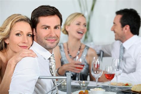 Board games are a great date night activity—they're both challenging and fun. Couples at a dinner party stock photo. Image of party ...