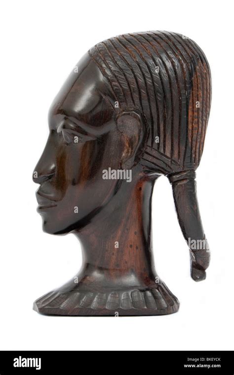 Side On View Of An African Ebony Wood Carving Of A Native African Woman Isolated On White