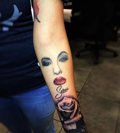 A Womans Arm With A Tattoo On It That Has A Face And Roses