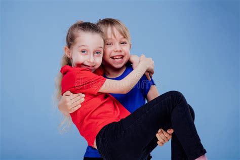 Cheerful Boy Carrying Girl In Studio Stock Image Image Of Affection