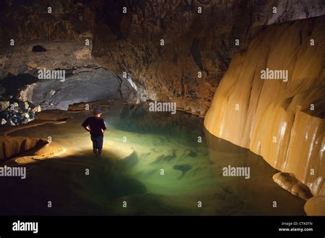 A Filipino Tour Guide Holds A Lantern Inside Sumaging Cave Or Big Cave