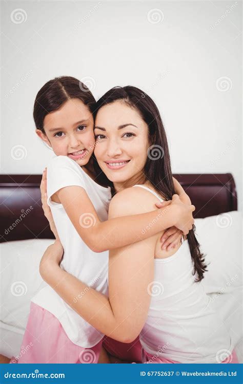 Portrait Of Happy Mother Hugging Daughter On Bed Stock Image Image Of Camera Cheerful 67752637