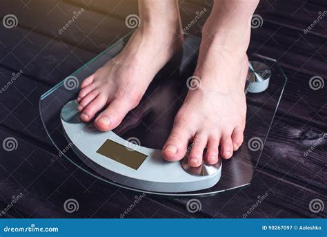 Female Feet Standing On Electronic Scales For Weight Control Stock