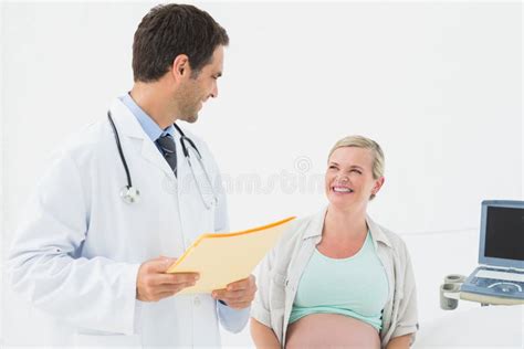 Smiling Pregnant Woman Having A Check Up With Doctor Stock Photo