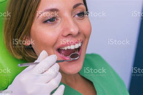 Closeup Of A Female Patient With An Open Mouth During Oral Checkup At