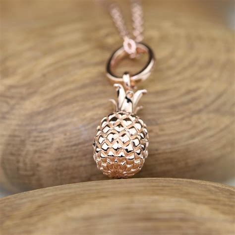 The blush color of rose gold is a combination of yellow gold and copper. rose gold pineapple pendant by nest | notonthehighstreet.com
