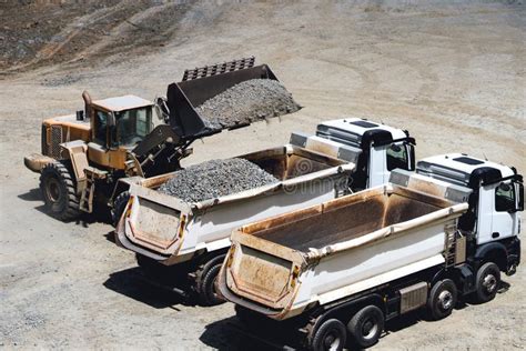 Dumper Trucks Being Loaded On Ore Mine Works At Open Pit Mine Stock
