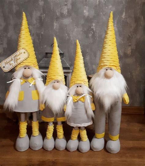 A Group Of Yellow And White Gnomes Standing Next To Each Other