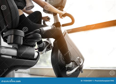 Legs Of Woman Biking In Gym Exercising Legs Doing Cardio Workout Cycling Bikes Stock Image