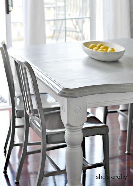 Charming white and blue dining room features white slipper dining chairs placed around a reclaimed wood dining table lit by a white rectangular lantern hung from a vaulted ceiling. 20 DIY Home Decor Ideas | Painted kitchen tables, Grey ...