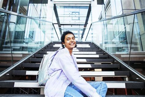 Young Cute Indian Girl At University Building Sitting On Stairs Stock