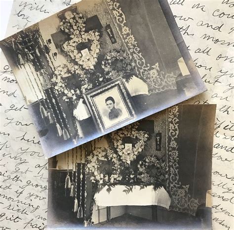 Two Old Photos Are Laying On Top Of Some Paper