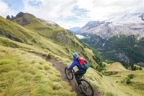 Young Woman Mountain Biking In The Dolomite Mountains Val Gardena