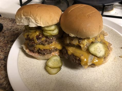 Double Smash Burgers With Cheddar Grilled Onions Pickles And Fry