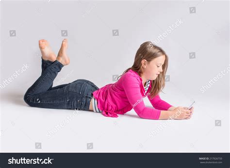 Photo De Stock Young Girl Lying On Stomach While 217926733 Shutterstock