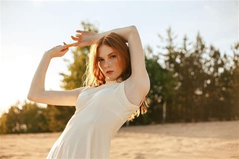 Premium Photo Confident Redhead Female Model In White Dress Standing