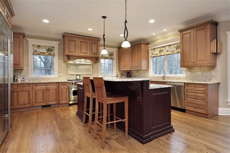 A Light Wood Kitchen With A Burgundy Island With A Small Eat In Counter