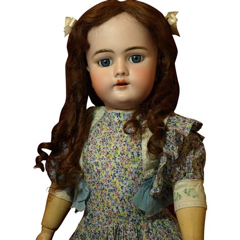 A Doll With Long Brown Hair And Blue Eyes